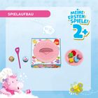 „SPIELAUFBAU“, „MEINE ERSTEN SPIELE! 2+“. Ein pinkes Einhorn und farbige Formen auf einem Teller, fröhlich bunt.