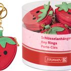 Schlüsselanhänger in Erdbeerform mit fröhlichem Gesicht und grünem Blattdesign, in einer durchsichtigen Dose verpackt.