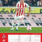 Text "Vorjahresabbildung", Kalender mit Fußballspielen, Spieler in rot-weißem Trikot, Logo mit Geißbock und "1. FC Köln".