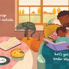 Text: "The air is crisp and cool outside. Let's get cozy under blankets!"  
Illustration zeigt eine gemütliche Herbstszene drinnen.