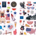 Das Bild zeigt viele bunte Sticker mit amerikanischen Symbolen, z.B. "Vote", "Passport", eine US-Flagge, "Route 66", "USA".