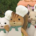 Freya, Ralph und Lyra feiern den Erfolg ihrer Kinderbäckerei. Illustration von fröhlichen Tieren mit Bäckermützen.