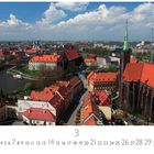Text: "Breslau 3 CASAES EDITION." 
Eine Stadtansicht mit roten Dächern, Fluss und Kirchen.