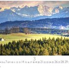 "Voralpenland", Kalender mit Märztagen, zeigt grünes Hügelland, Nadelwälder und verschneite Alpen.