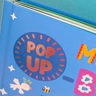 Text "POP UP" auf blauem Buchdeckel. Bunte Illustrationen von Tieren und Sternen, Teil eines Kinderbuchs.