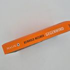 Orangefarbener Buchrücken, Text: "Malik", "Reinhold Messner", "Gegenwind". Klare, simple Gestaltung.