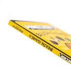 Text: "BRAIN GAMES", "MOZABRICK". Gelber Hintergrund mit bunten Mustern, vielleicht ein Buch oder ein Spielverpackung.