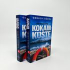 Zwei Bücher mit dem Titel "Kokain Küste" von Gerold Hänel. Cover zeigt stürmisches Meer mit Rettungsring. Kriminalroman.