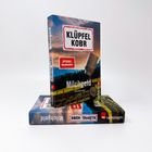 Texte: KLÜPFEL KOBR, SPIEGEL Bestseller, Milchgeld, Kriminalroman. Ein aufrecht stehendes Buch zeigt eine ländliche Szene.