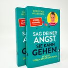 Zwei Bücher mit der Aufschrift „Sag deiner Angst, sie kann gehen!“. Eines zeigt eine Frau im Kreis.