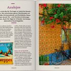 Azulejos: Portugals typische Keramikfliesen, dekorativ und funktional. Foto: Hausfassade mit Bike und blühendem Baum.