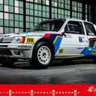 Der Text "MAI" steht links unten. Ein Rallyeauto mit Sponsorenlogos, darunter Mobil und Michelin, steht in einer Halle.