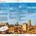 "Zahlen, bitte!" Einige Zahlen zu Bologna, inklusive Cappuccino-Preis: 1,60 und Einwohner 387.842. Stadtansicht mit Türmen.