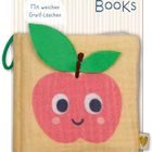 Text oben: "Mit weichen Greif-Laschen." Darunter ein Spielbuch mit lächelndem Apfel und grünen Blättern.