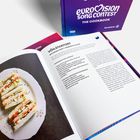 "VÕILEIVATORT ESTONIAN PARTY SANDWICH CAKE" Rezeptseite; daneben ein Buch mit "Eurovision Song Contest The Cookbook".