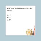 "Wie viele Gemeindebezirke hat Wien? a) 21 b) 22 c) 23" Illustration mit Wiener Skyline-Silhouetten in der Ecke.
