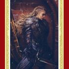 Eine blonde Kriegerin in Fell, mit Schwert, steht vor einer Ziegelmauer. Verziert mit rotem und goldenem Rahmen.