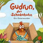 „Gudrun, das Schokohuhn. Ein Osterwunder.“ 
Ein illustriertes Huhn in einer Box mit Schleife, umgeben von Osterdekoration.