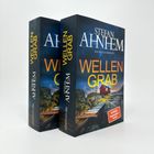 Zwei Bücher mit dem Titel "WELLENGRAB". Autor: Stefan Ahnhem. Kriminalroman. Hintergrund: Haus auf Felsenküste.