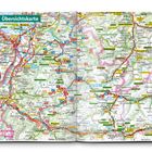 Überschrift "Übersichtskarte", zeigt Straßen und Orte in einer bergigen Region. Enthält Details zu Parks und Routen.