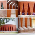 "CNE: SANKARA THOMAS" steht auf einer orangen Ziegelfassade. Moderne Architektur mit hohen, dreieckigen Maueröffnungen.