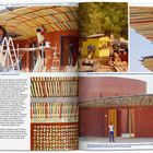 Texte: "The entrance pavilion under construction.", "The kiosk of Sankara's brother Valentin, before it was integrated into the pavilion design.", "The entrance pavilion's roof, under construction, includes logs painted in 13 different colors, representing President Sankara and his 12 compatriots."

Links: Arbeiter auf Leiter, konstruieren Dach. Rechts oben: Gelber Kiosk, Holzstapel. Unten: Rundes Backsteingebäude, bunt bemalte Dachbalken.