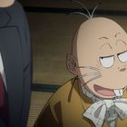 Ein kahlköpfiger Zeichentrickcharakter mit Schnurrbart lächelt verschmitzt und trägt einen karierten Schal.