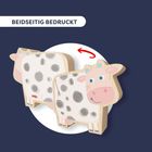 "Beidseitig bedruckt." Illustration einer lächelnden Kuh mit grauen Flecken, die aus Holz gefertigt scheint.