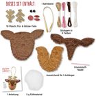 Text: "DIESES SET ENTHÄLT: 10 Plüsch, Filz- & Glitzer-Teile, 1 Satinband, Stickgarn in 4 Farben, 1 Anleitung, 5 g Füllmaterial."