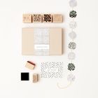 Links "CONGRATULATIONS" auf einer Box, unten "HAPPY BIRTHDAY" auf einer Karte. Stempel und runde Muster aufgereiht.