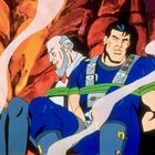 Zwei Männer, gefesselt mit grünen Seilen, sitzen vor einem feurigen Hintergrund. Eine rauchige Atmosphäre umgibt sie.