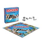 "Monopoly Hundebabys" in großen Buchstaben auf der Schachtel und Spielfeld. Zeigt süße Hundewelpen und Spielfiguren.