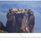 Kloster Meteora. Unter einer Zahlenreihe ist auf einem Felsen ein Kloster in malerischer Landschaft zu sehen.