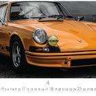 "Porsche Carrera RS" und "CIBIE" auf gelben Scheinwerfern. Ein klassisches, orangefarbenes Auto von vorn.