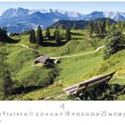 "Wilder Kaiser, Tirol" und Ziffern von 1 bis 30. Eine sonnenbeschienene Alm mit Bank, Hütte und Bergpanorama.