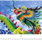 „Chinesischer Drachen“ steht unter einem bunten, kunstvollen Drachen, der lebendig wirkt, vor einem blauen Himmel.