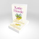 Der Text auf dem Buch lautet: "Katie Fforde, Glück auf der Sommerinsel, Roman, Lübbe". Ein illustratives Cover mit Palmen.