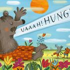 „UAAAH! HUNGER!“, ruft ein großes, sitzendes, glückliches Tier inmitten von bunten Blumen und kleinen Tieren.