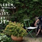 „EIN LEBEN, DAS WIRKLICH ZU MIR PASST, KOSTET MUT“ Schriftstellerin Esther Freud. Frau sitzt im grünen Garten.