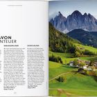 Titel: "Mehr davon Bergabenteuer". Artikel über Fahrradstrecken. Rechts ist ein Foto von malerischen Bergen und einem Dorf.
