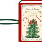 "Frances H. Burnett Der Kleine Lord". Rotes Buch mit Tannenbaum, dekoriert mit Schleife und Kugeln. Festliches Design.