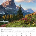 Kalender: April 2027. Tage in Spalten von Montag bis Sonntag angeordnet. Foto: Blumenwiese vor einem Bergmassiv.