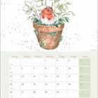 Kalenderseite mit April, Wochenübersicht, Illustration: Rotkehlchen sitzt in einem Blumentopf mit weißen Blumen.