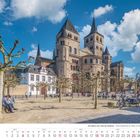 Text: "Die Mosel von Trier bis Koblenz" April 2027. Szenenbild mit alten Bäumen, Menschen und einer großen historischen Kirche.