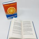 "SOPHIA MERWALD SPERRGUT ROMAN" steht auf einem Buchcover mit einer Orange. Ein offenes Buch daneben zeigt Text.