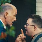 Zwei Männer stehen sich nahe gegenüber. Einer scheint energisch, der andere hört aufmerksam zu, beide im Profil.