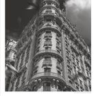 Zahlen von 1 bis 31, 10 hervorgehoben; darunter "DUMONT". Eine historische, mehrstöckige Gebäudefassade.