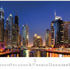 Text: "Dubai, Hafen", "CASARES EDITION", Zahlen von 1 bis 31. 

Szene: Nachtansicht von beleuchteten Hochhäusern am Wasser.