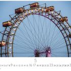 5, Prater, 1-31, CASARES EDITION. Ein beleuchtetes Riesenrad im Abendlicht mit roten Gondeln.
