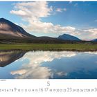 "Berglandschaft bei Gällivare, Lappland." zeigt Berge am Horizont, blauen Himmel, Wolken und ihre Spiegelung im Wasser.